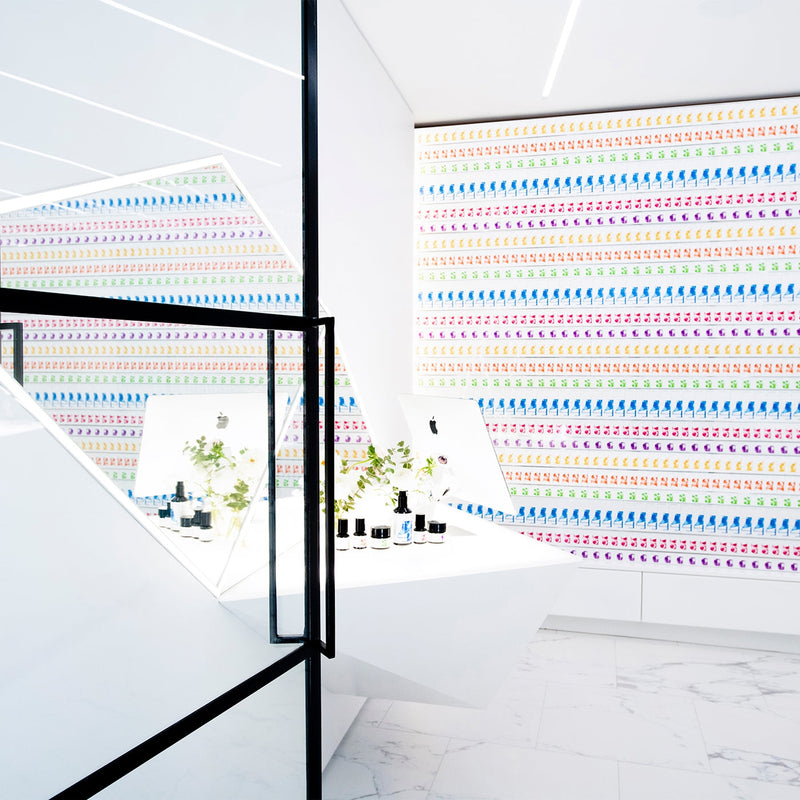 Modern interior with colorful patterned walls and a glass partition.