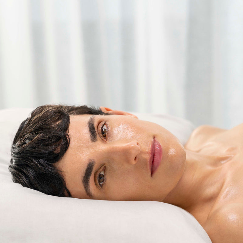 Woman lying on a white surface with a neutral expression