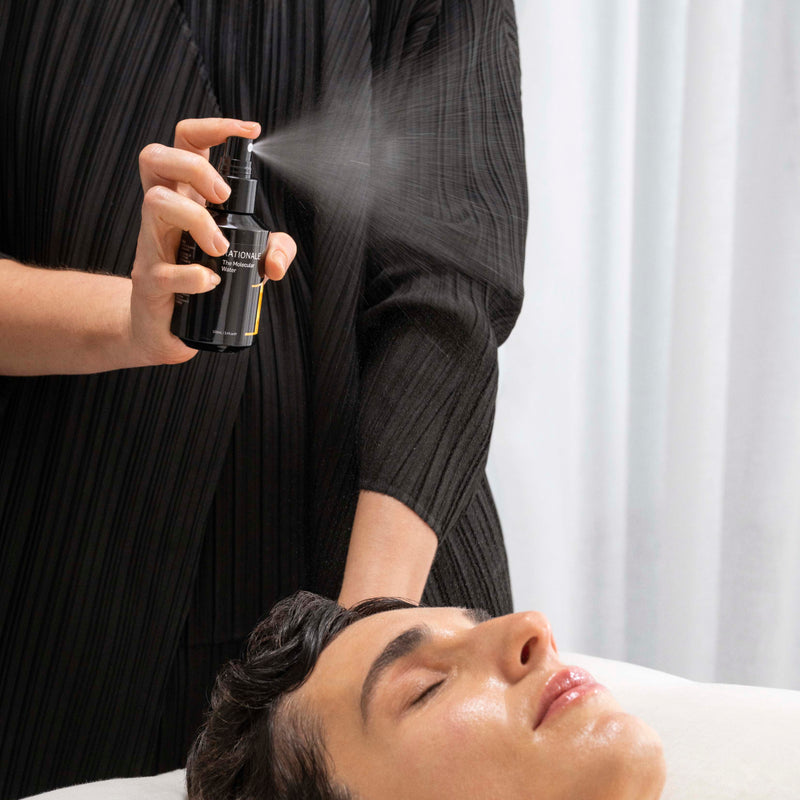 Person applying a spray product to another person