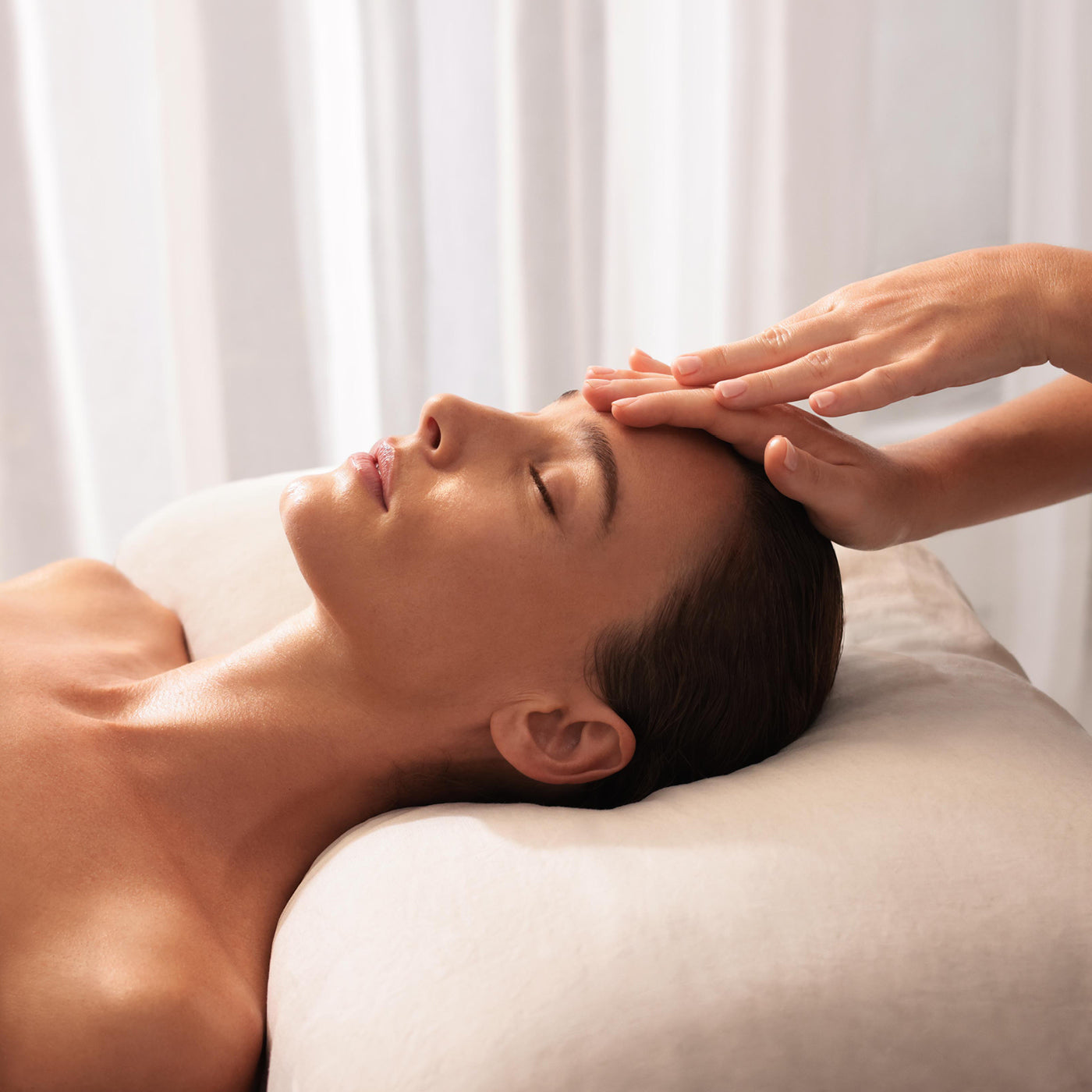 Person receiving a head massage in a serene setting