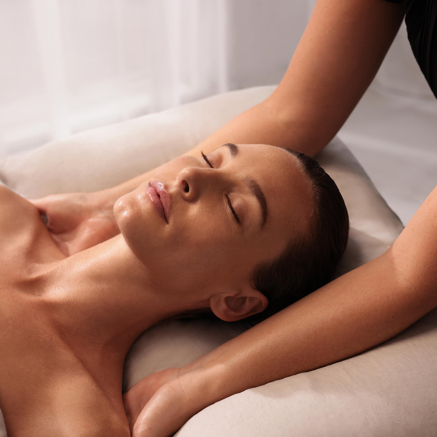 Person receiving a massage with a neutral background