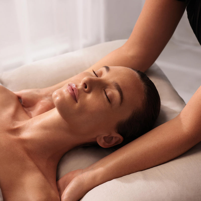 Person receiving a massage with a neutral background