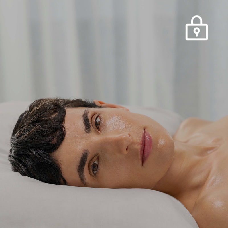 Person lying on a white surface with a neutral background
