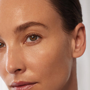 Close-up of a woman's face with a neutral background